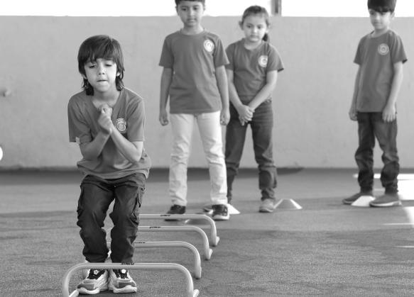 Children stepping over low hurdles